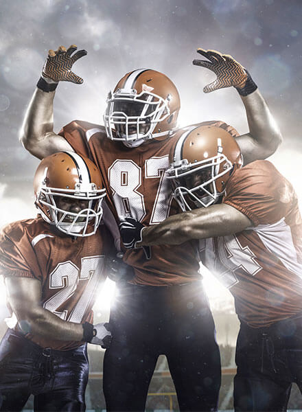 Multiple hands stacked together in a high five team huddle
